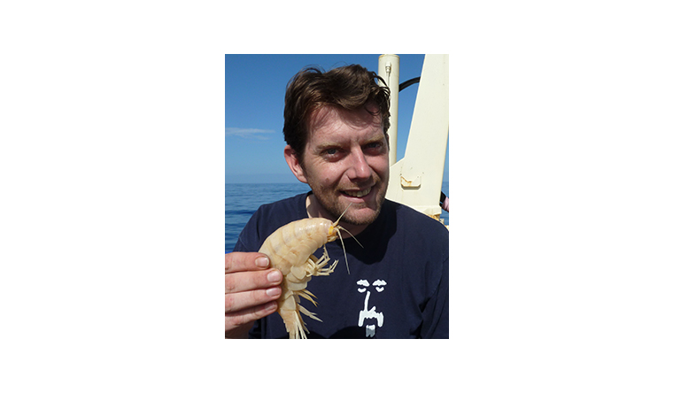 profile picture of Professor Alan Jamieson holding the largest amphipod