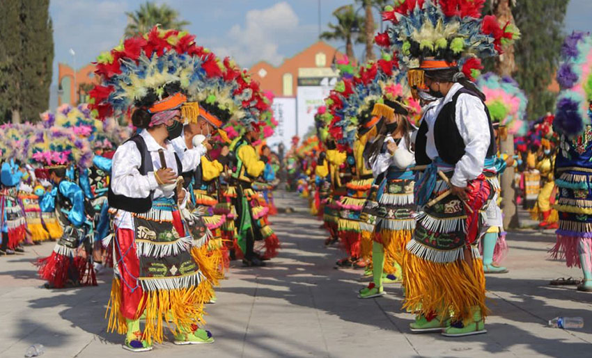 People in colourful headdresses at a festival
