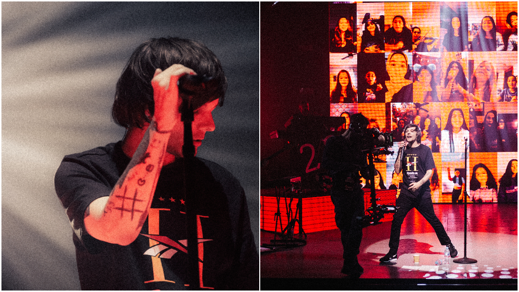 Louis Tomlinson holding a mic and singing